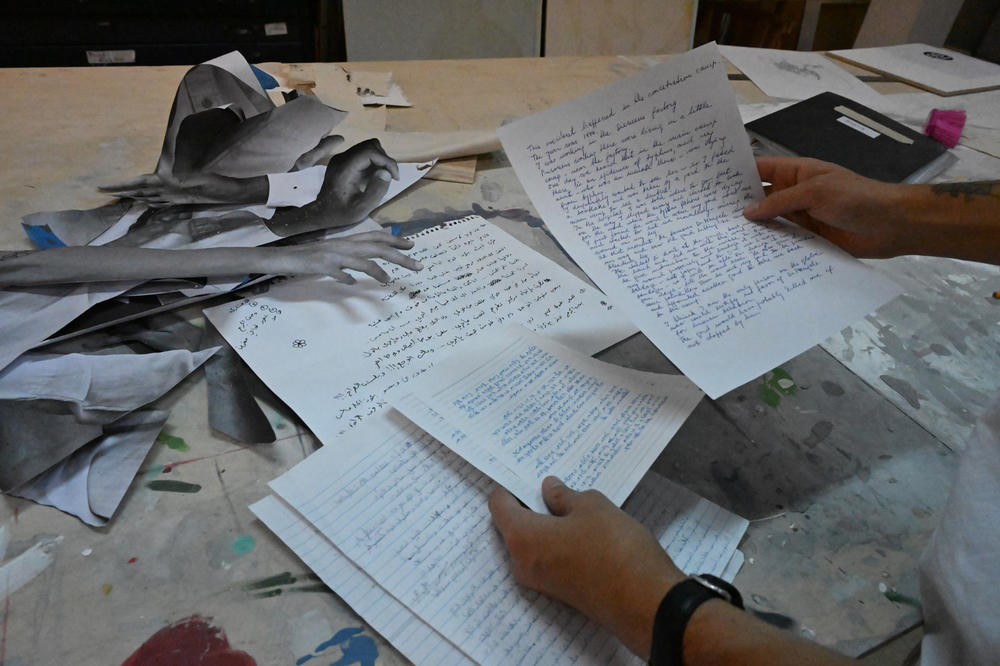 Artist Addam Yekutieli works with testimonials to make a collage.