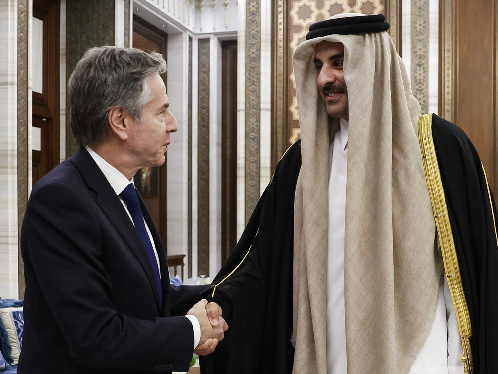 U.S. Secretary of State Antony Blinken, left, shakes hands with Qatar's Emir Sheikh Tamim Bin Hamad Al Thani, during Blinken's week-long trip aimed at calming tensions across the Middle East, at Lusail Palace in Lusail, Qatar, on Sunday.
