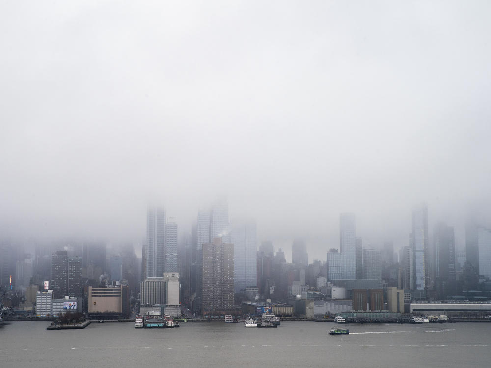The Skyline of Middle Manhattan and the Empire State Building are seen covered during a winter storm in New York as it is seen from Weehawken, N.J., on Sunday.
