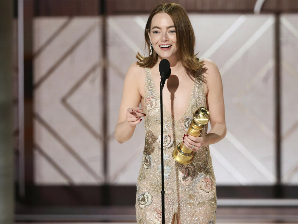 This image released by CBS shows Emma Stone accepting the award for best female actor in a motion picture for her role in 