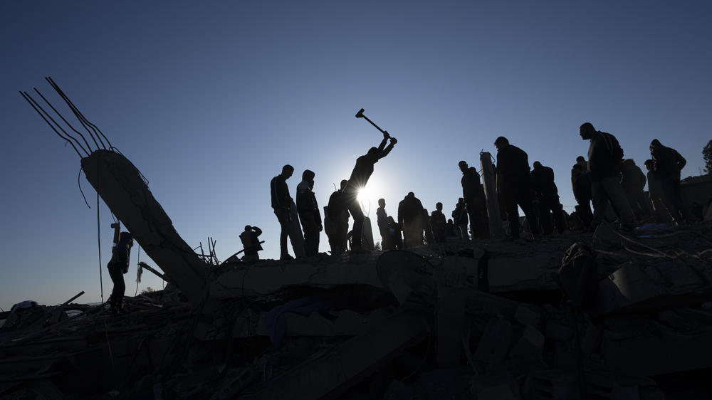 Palestinians search for bodies and survivors in the rubble of a house destroyed in an Israeli airstrike, in Rafah, southern Gaza Strip, on Sunday.