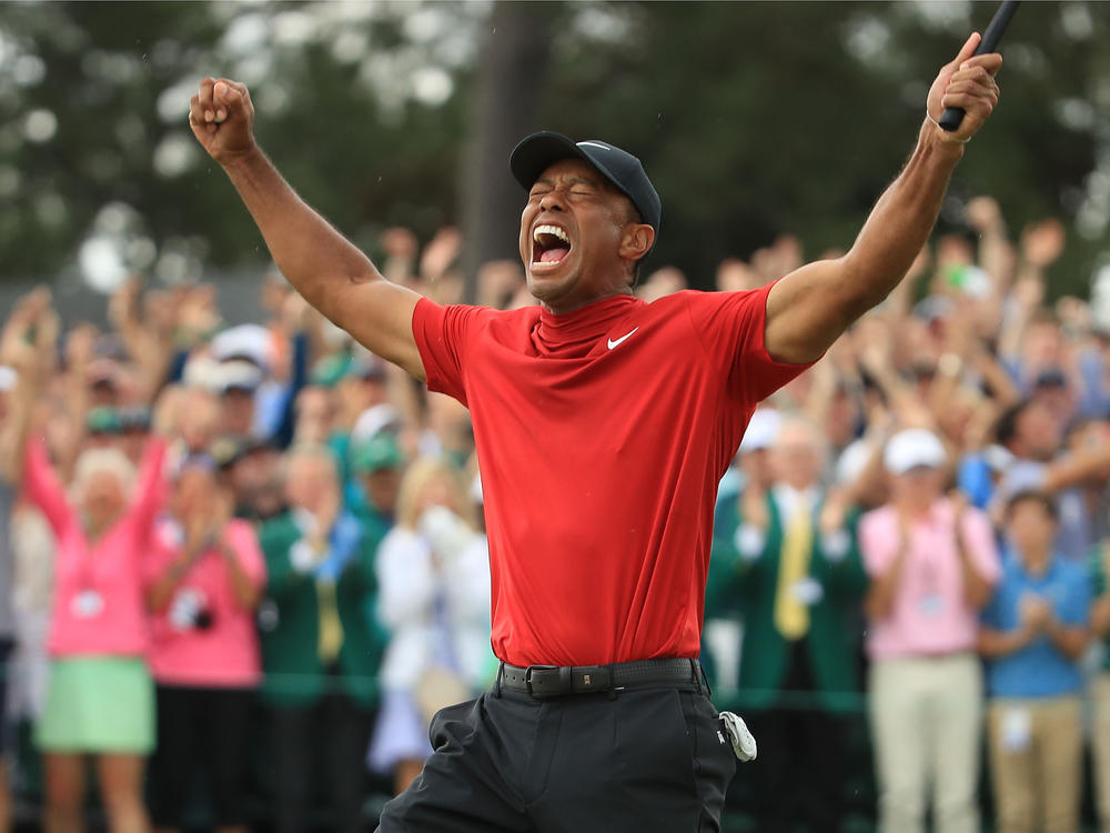 Tiger Woods celebrates on the 18th green after winning the Masters at Augusta National Golf Club on April 14, 2019 in Augusta, Georgia.