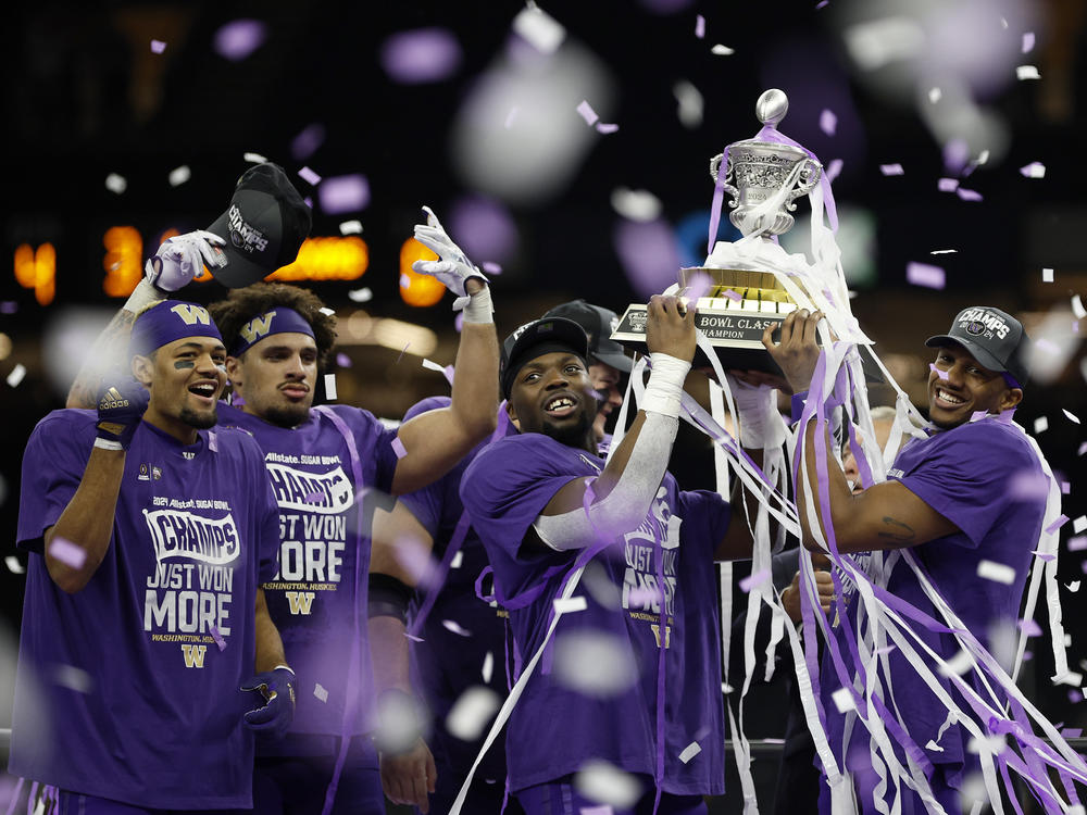 The Washington Huskies, seen here celebrating with the trophy after beating the Texas Longhorns in the Sugar Bowl in New Orleans, quickly rebuilt its roster by using transfers and players from out of state — particularly California.