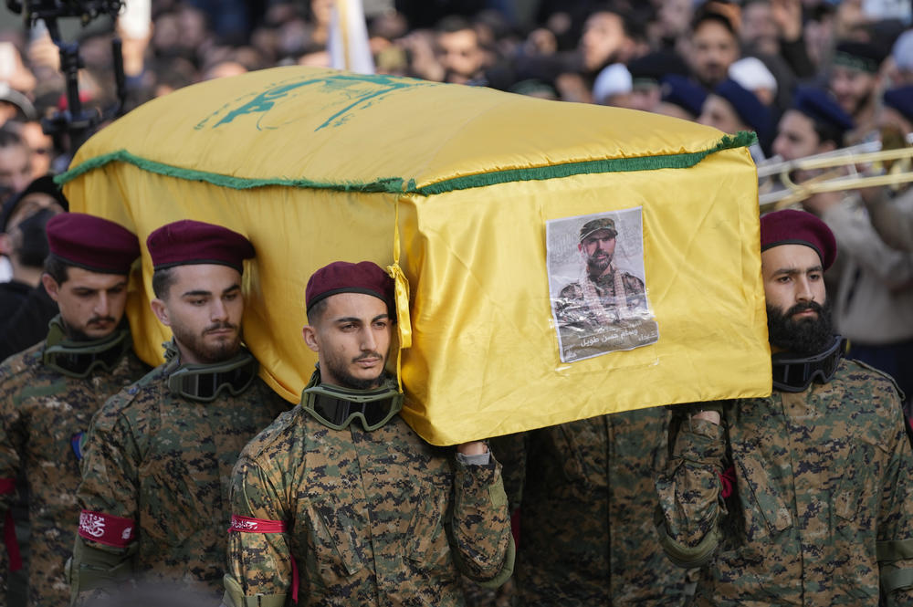 Hezbollah fighters carry the coffin of senior Hezbollah commander Wissam Tawil, during his funeral procession in the village of Khirbet Selm, south Lebanon, on Tuesday. The elite Hezbollah commander was killed in an Israeli airstrike on Monday in southern Lebanon.