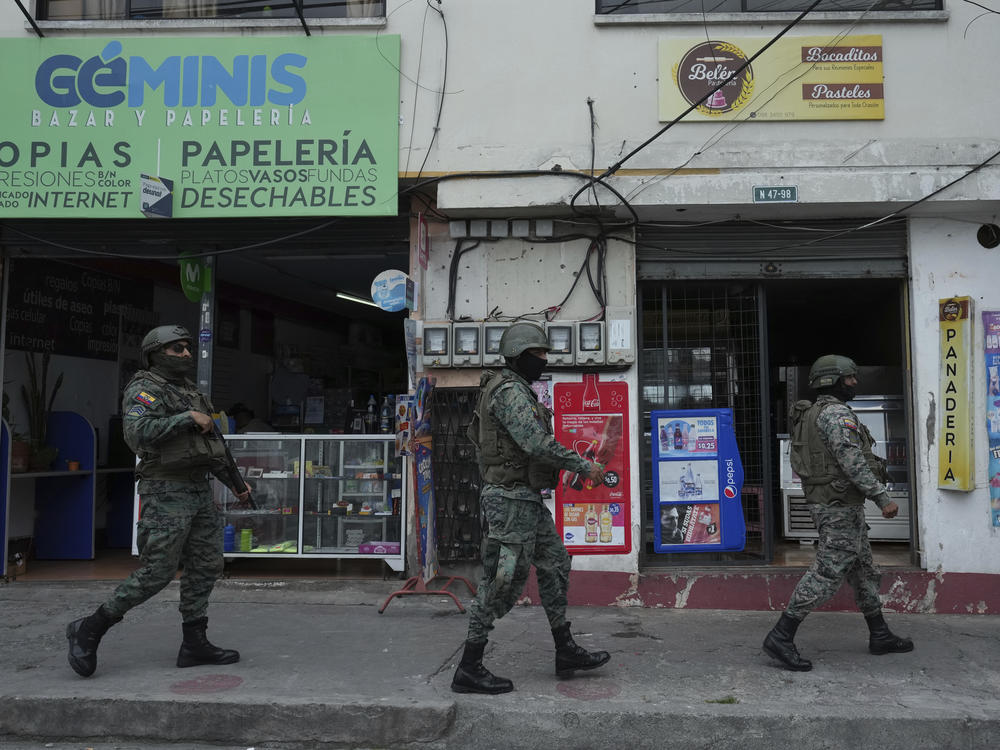 Soldiers patrol the perimeter of Inca prison during a state of emergency in Quito, Ecuador, on Tuesday in the wake of the apparent escape of a powerful gang leader from prison.