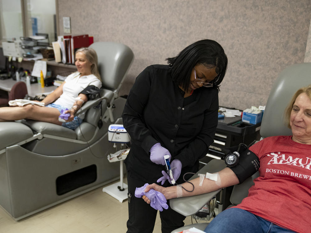 Tuyishimire Primitiva, phlebotomist with the American Red Cross, draws whole blood from Teresa McLeland at the American Red Cross on April 12, 2023, in Louisville, Ky.