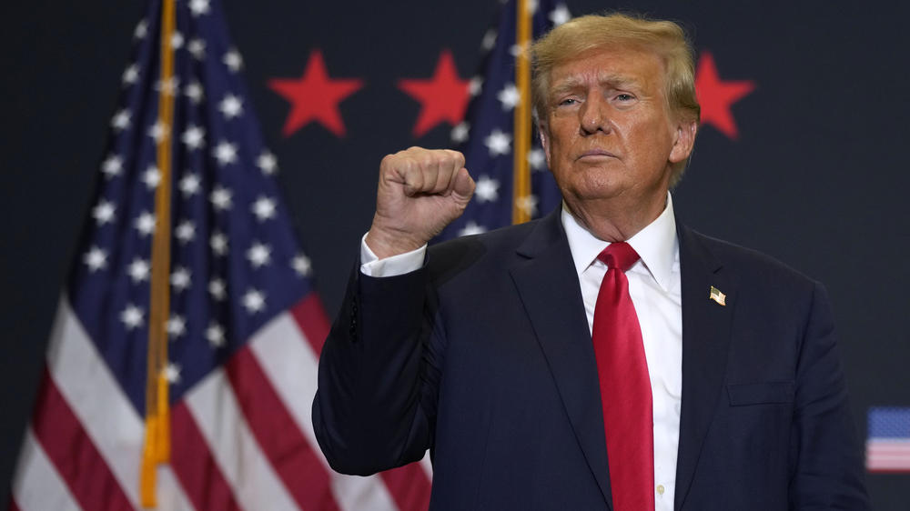 Former President Donald Trump reacts to supporters during a commit to caucus rally, Tuesday, Dec. 19, 2023, in Waterloo, Iowa.