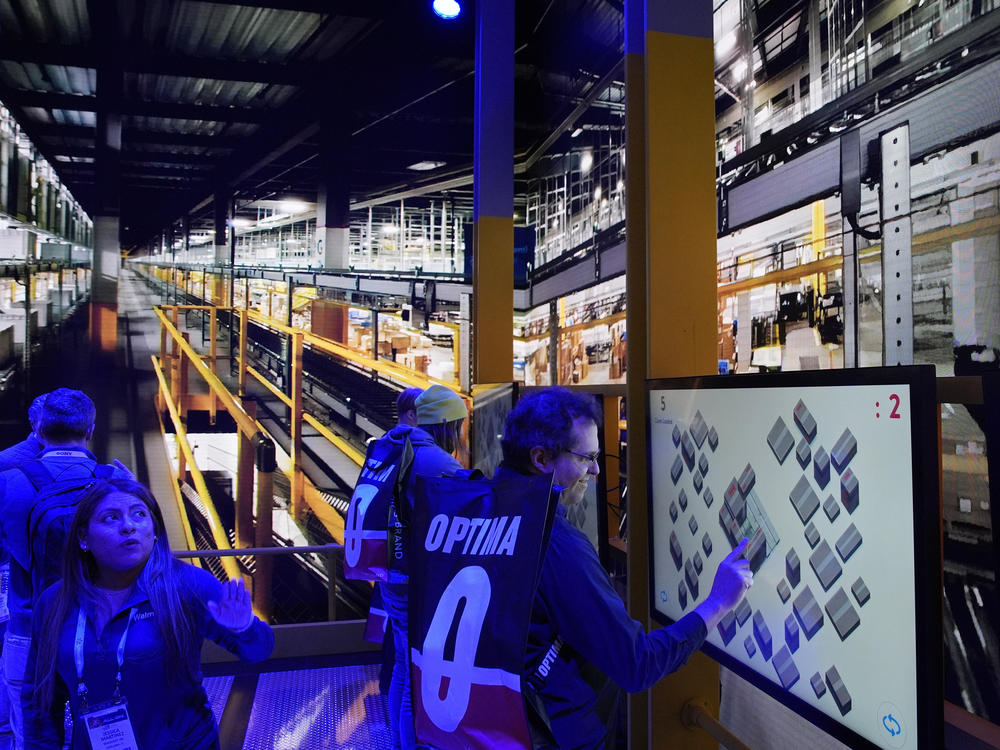 People play a pallet packing game at the Walmart booth during the CES tech show Tuesday, Jan. 9, 2024, in Las Vegas.