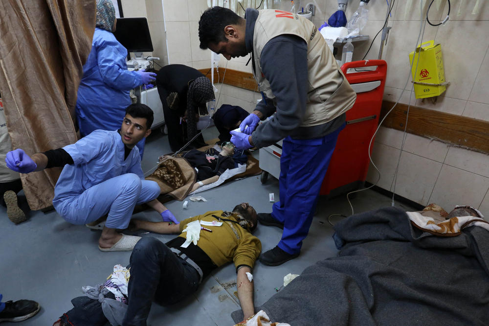 People injured in an Israeli bombardment receive medical care at the emergency ward of al-Aqsa hospital on Dec. 30.