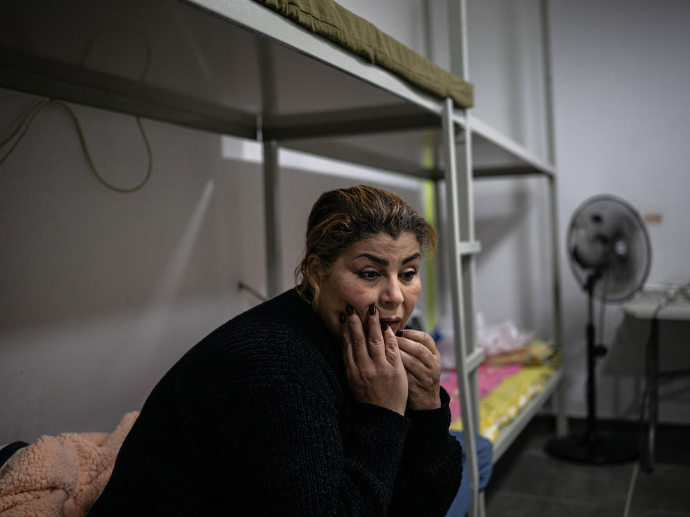 Sisilya al-Ousi sits in her apartment building's bomb shelter, where she spends most of her time.