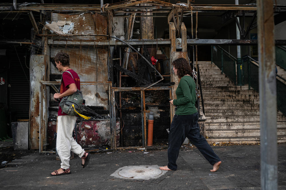 People pass by a restaurant that was destroyed in a Hezbollah rocket attack in November in Kiryat Shmona.