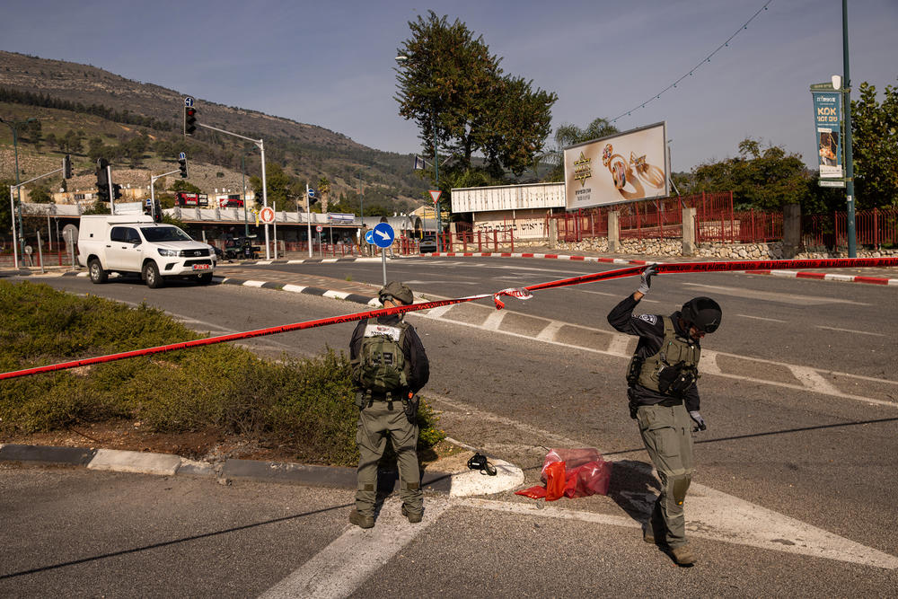 Israeli police inspect the area where an anti-tank missile fired from Lebanon landed in Kiryat Shmona, Israel, on Monday. Kiryat Shmona was evacuated as hostilities with Hezbollah escalated following the Oct. 7 attacks, but some residents have chosen to remain.