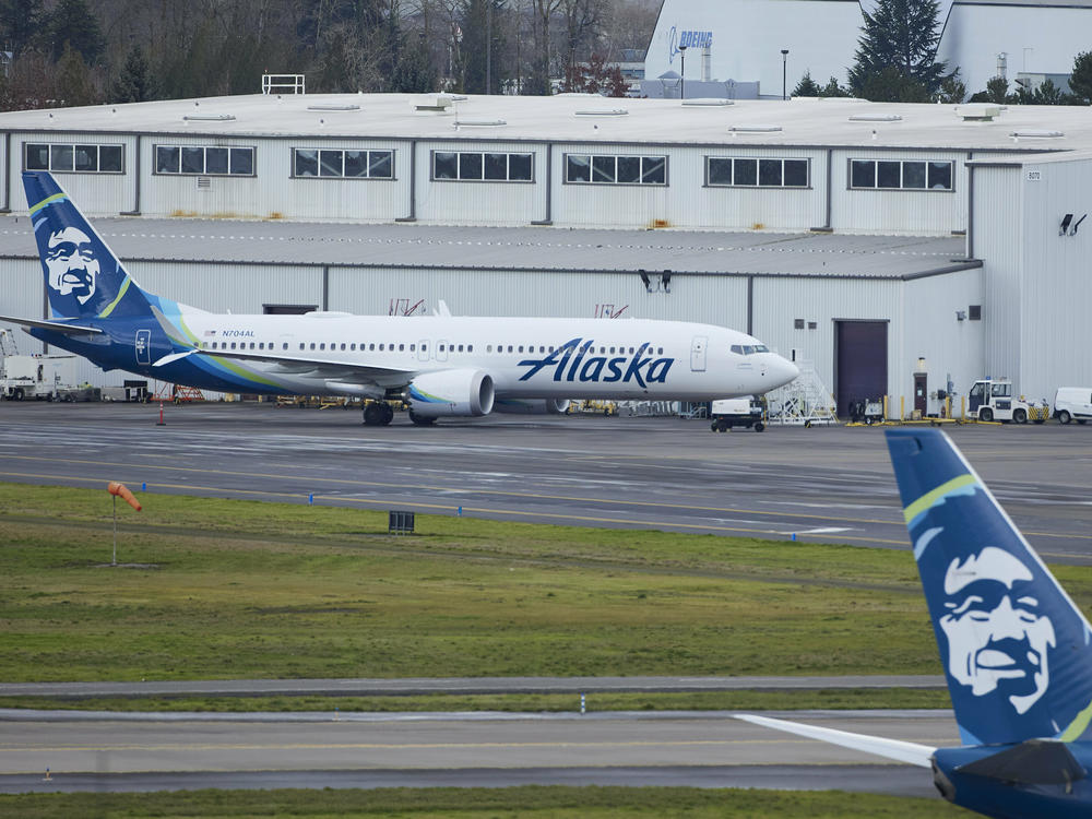 Alaska Airlines N704AL, a 737 Max 9 which made an emergency landing at Portland International Airport after a part of the fuselage broke off mid-flight on Friday, is parked at a maintenance hanger in Portland, Ore., Saturday, Jan. 6, 2024.