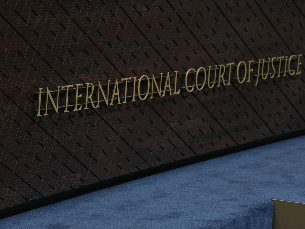 The logo of the International Court of Justice, left, and that of the U.N., right, are seen on the judges bench at the International Court of Justice, or World Court, in The Hague, Netherlands, Thursday, Oct. 12, 2023.