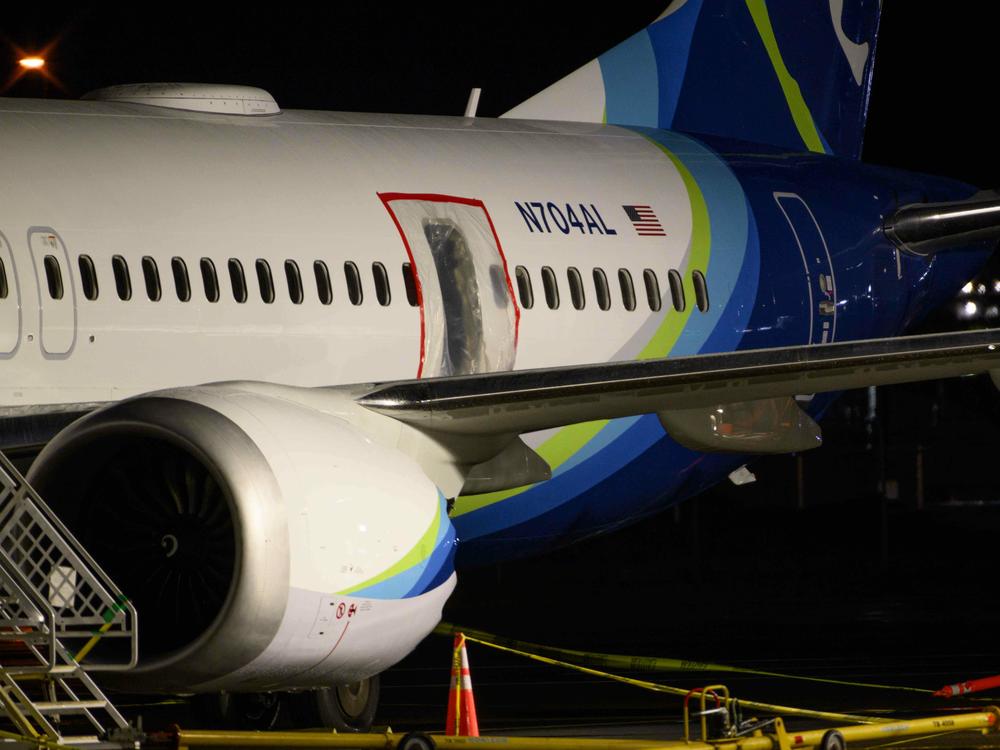 A plastic sheet covers part of the fuselage of an Alaska Airlines Boeing 737 Max 9 at Portland International Airport on Jan. 8. NTSB investigators are trying to learn why the aircraft suffered a midair fuselage blowout last Friday.