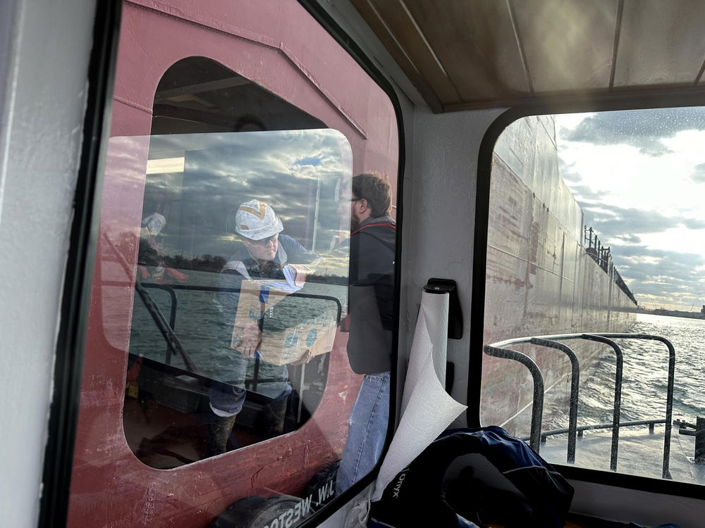 Sailors on the Great Republic, a Great Lakes bulk cargo carrier built in 1981, receive their mail on the Detroit River.