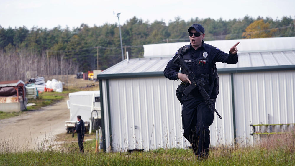 A police officer gives an order to the public Oct. 27 during a manhunt for Robert Card at a farm in Lisbon, Maine, following two mass shootings in nearby Lewiston. Despite the warning by Card's friend and fellow Army reservist Sean Hodgson, Army officials ultimately did not stop Card from committing Maine's deadliest mass shooting.