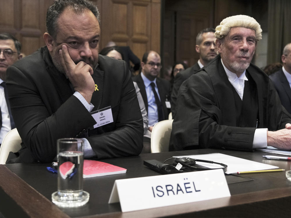 British jurist Malcolm Shaw, right, legal adviser to Israel's Foreign Ministry Tal Becker, left, look on during the opening of the hearings at the International Court of Justice in The Hague, Netherlands, Thursday, Jan. 11, 2024.