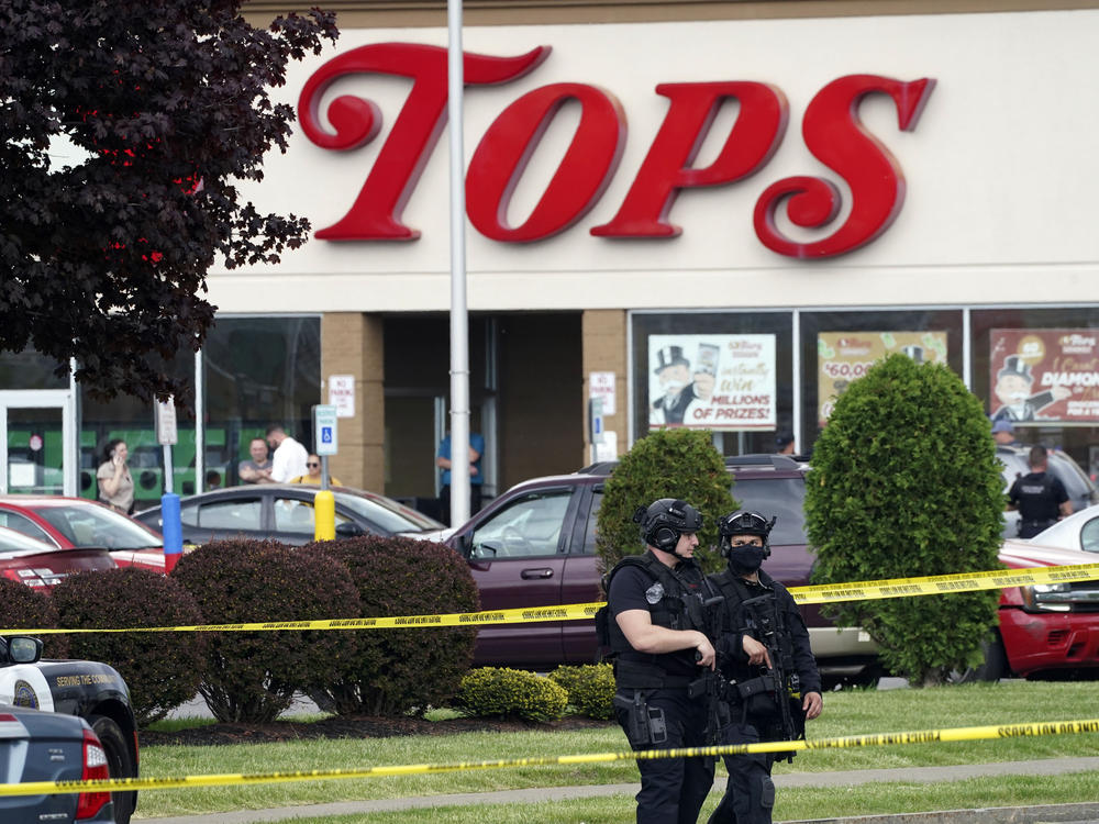 Police secure an area around a Buffalo, N.Y., supermarket where 10 people were killed in a shooting on May 14, 2022.