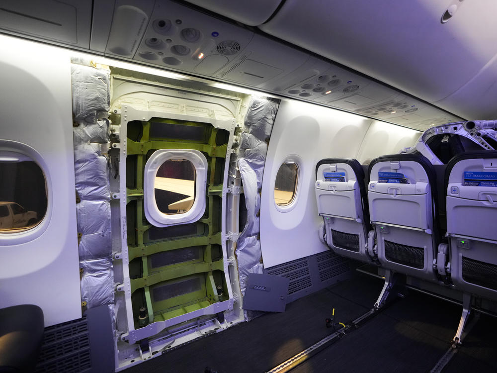 The door plug area of an Alaska Airlines Boeing 737 Max 9 aircraft, seen with the paneling removed, awaits inspection Wednesday at the airline's facilities at Seattle-Tacoma International Airport in SeaTac, Wash.