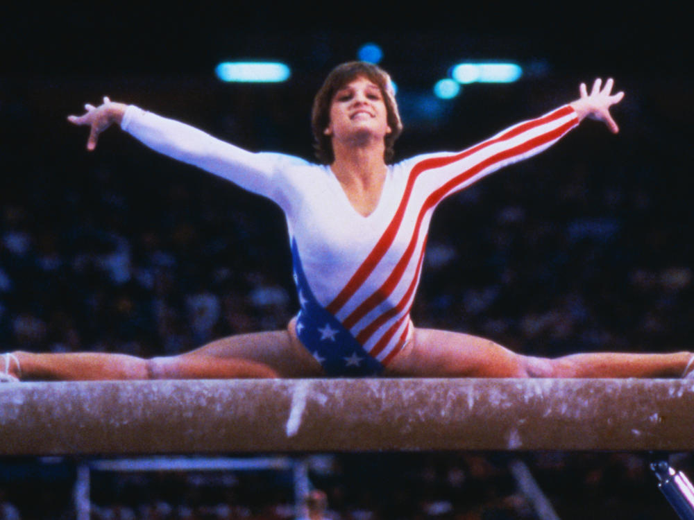Mary Lou Retton performs on the balance beam in the 1984 Olympics in Los Angeles. Last week, she said she couldn't afford health insurance and owes big hospital bills after a serious illness.