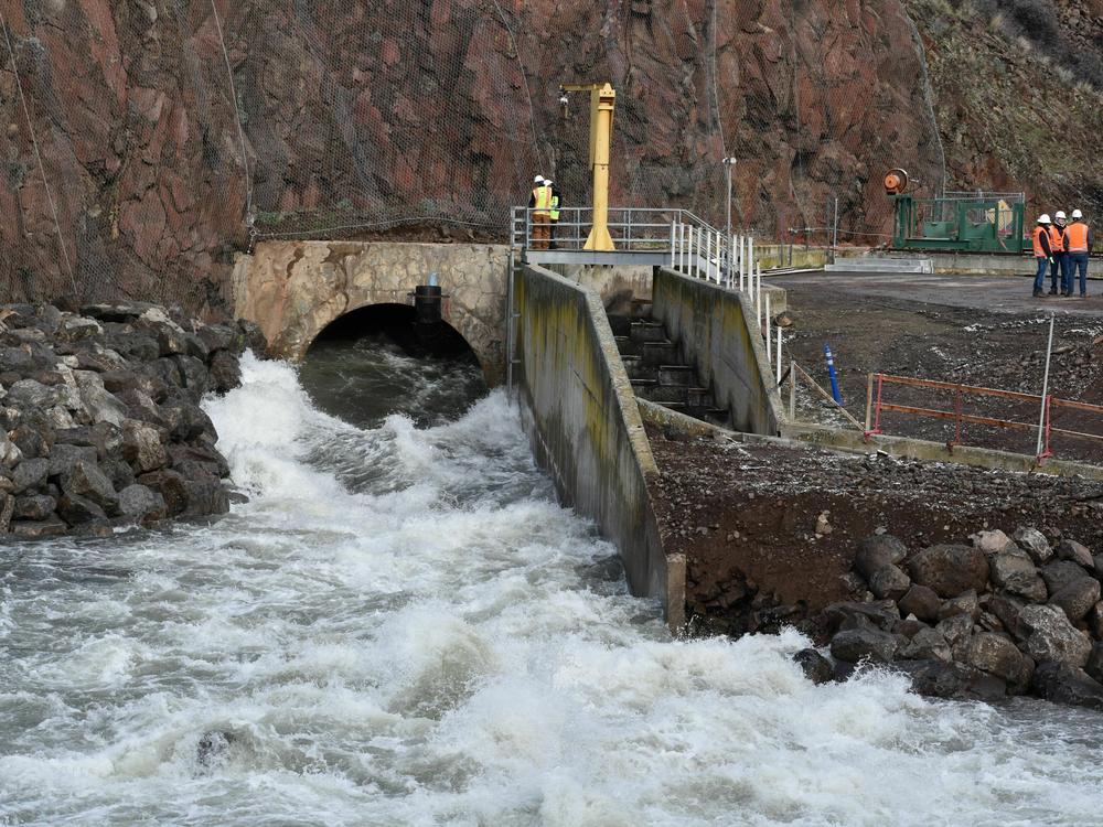 The bypass tunnel at the bottom of Iron Gate Dam in Northern California has been carefully reinforced so it can handle the load of water and sediment pouring through it.