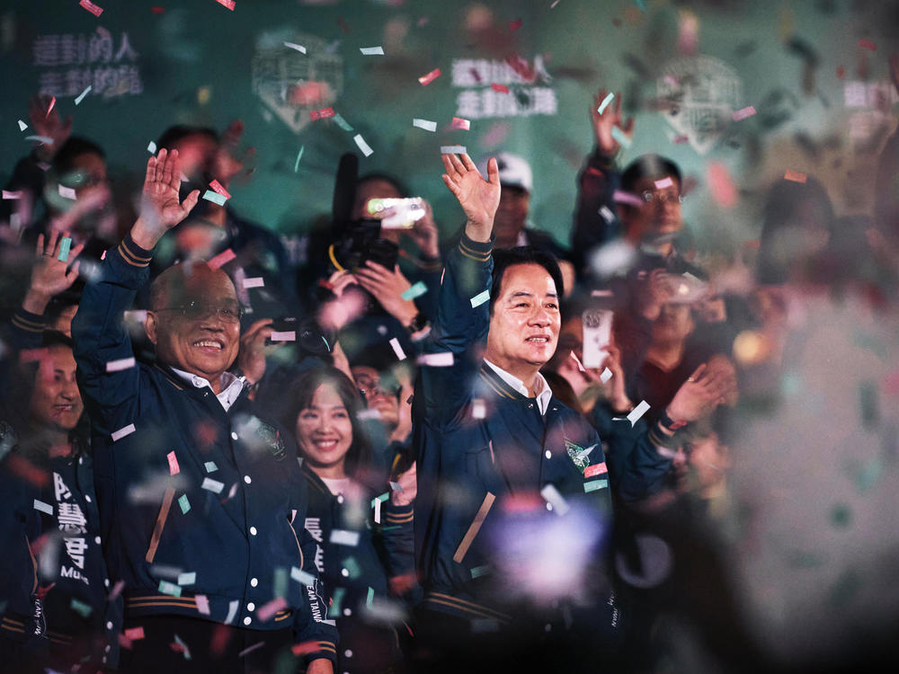 Lai Ching-te, Taiwan's president-elect (center) appears at an election night rally outside the Democratic Progressive Party headquarters in Taipei, Taiwan, on Saturday.
