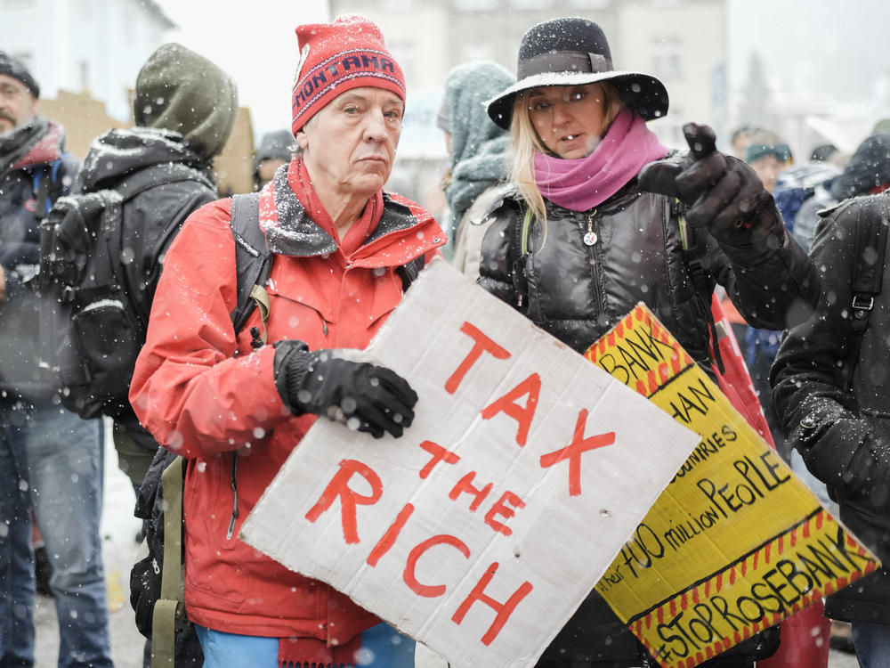 A demonstration at the annual meeting of the World Economic Forum in Davos, Switzerland, in 2023. A perennial Davos topic is how to improve the lives of the world's poor.