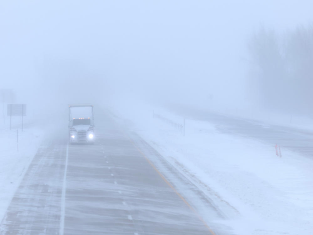 A truck travels on Interstate 25 during blizzard-like conditions on Saturday, in Blencoe, Iowa. The second winter weather system in a week is bringing harsh conditions across Iowa as voters prepare for the Republican Party Iowa presidential caucuses on Monday.