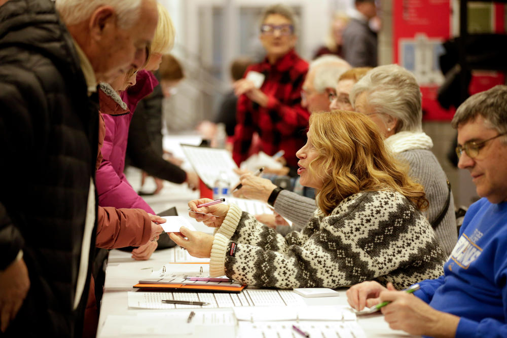 Voters signing up to caucus at the West Des Moines caucus site on Jan. 15, 2024.