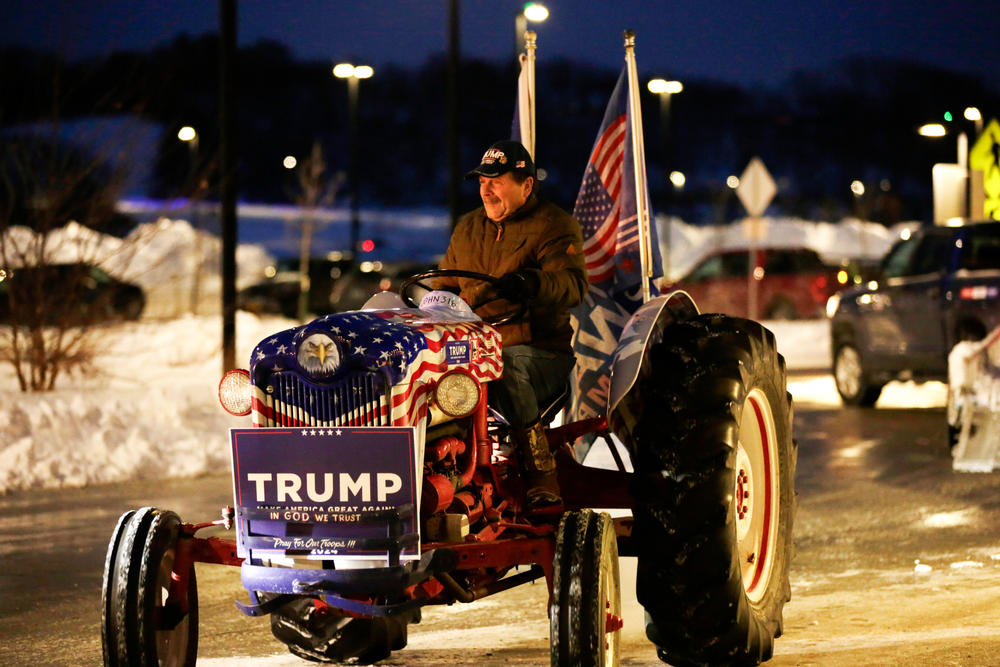 A supporter of Donald Trump drives a decorated tractor outside of the West Des Moines caucus site on Jan. 15, 2024.