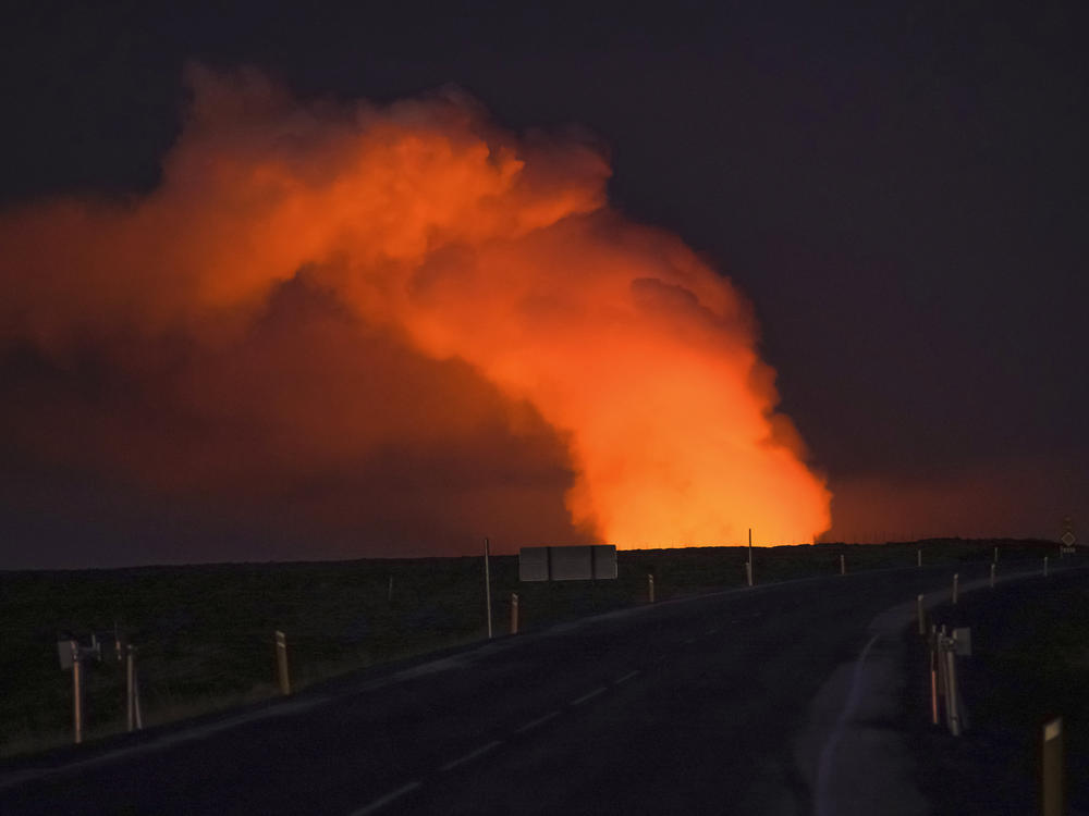 A view of the plume of gas lighted up by the lava from the erupting volcano seen from Suðurstrandavegur, the road that leads to Grindavík, Iceland, on Sunday.