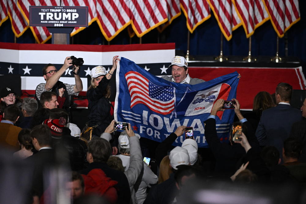 Supporters of former US President and Republican presidential hopeful Donald Trump celebrate at a watch party during the 2024 Iowa Republican presidential caucuses in Des Moines, Iowa, on Jan. 15, 2024.