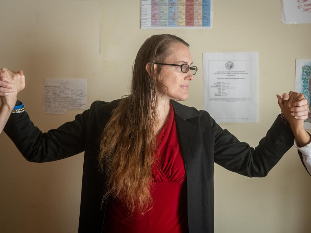 Hannah Russell, a former special education teacher, holds the hands of her two children at home in North Carolina. She says that even when parents present pictures of injured children following restraint and seclusion, school systems will say 