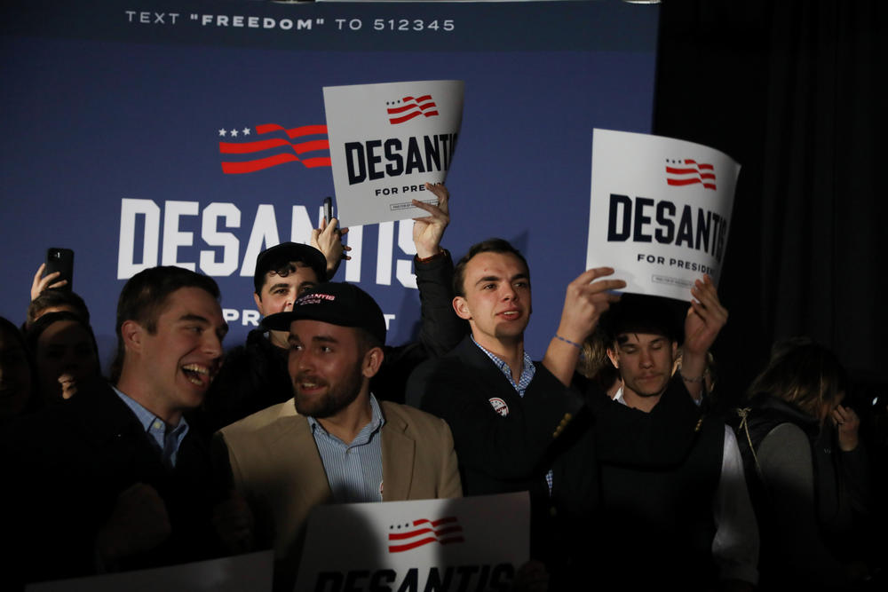 Supporters of Republican presidential candidate Ron DeSantis hold up signs at a watch party during the 2024 Iowa Republican presidential caucuses in West Des Moines, Iowa, on Jan. 15, 2024.