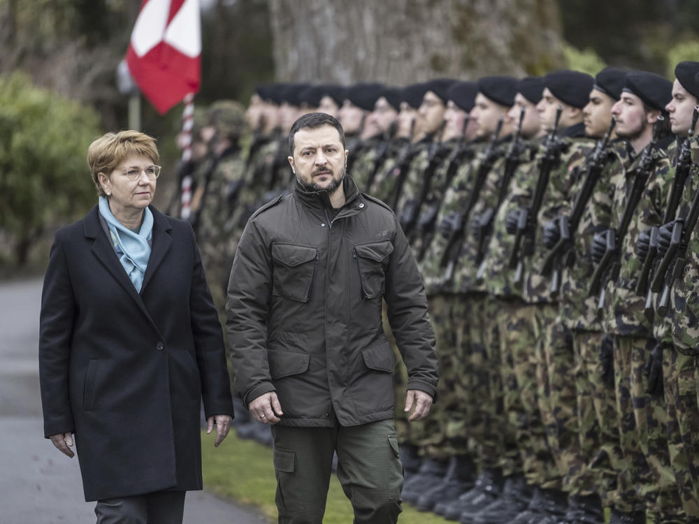 Swiss Federal President Viola Amherd, left, and her guest, Volodymyr Zelenskyy, right, President of Ukraine, inspect the guard of honour in Kehrsatz near Bern, Switzerland, Monday, Jan. 15, 2024.