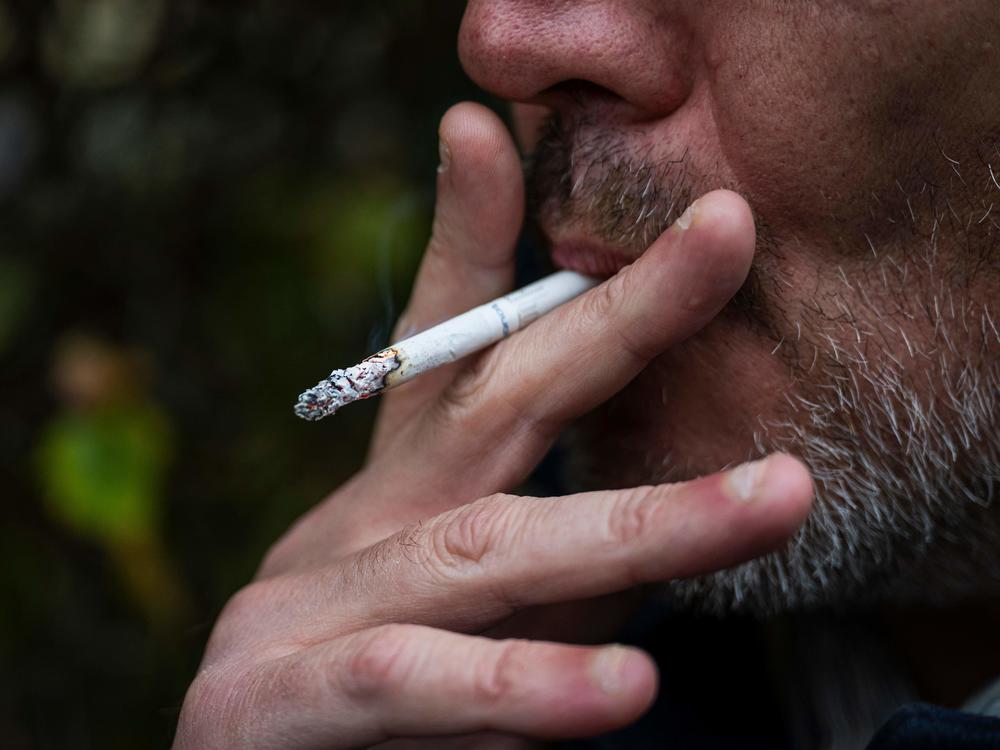 This picture taken on Oct. 31, 2023, shows a man smoking a cigarette in Sundbyberg, near Stockholm, Sweden. The WHO has issued a new report on global tobacco use, finding rates are going down.