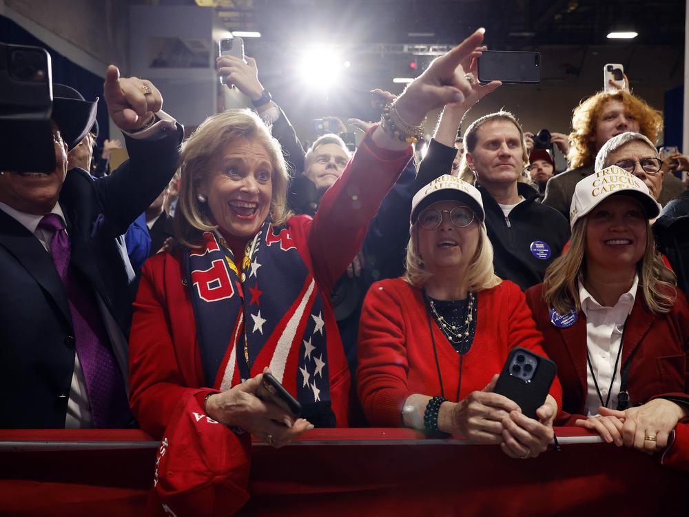 Supporters of former President Donald Trump cheer during his caucus night event in Des Moines, Iowa.
