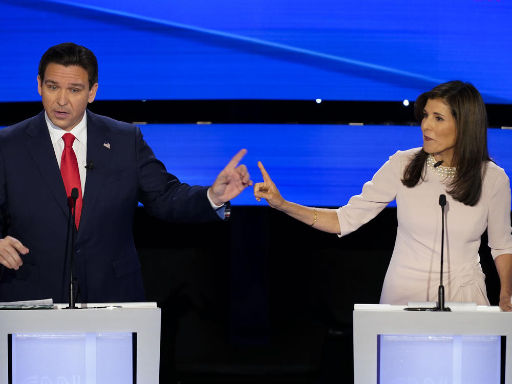 Former UN Ambassador Nikki Haley, right and Florida Gov. Ron DeSantis, left, pointing at each other during the CNN Republican presidential debate at Drake University in Des Moines, Iowa, Jan. 10, 2024.