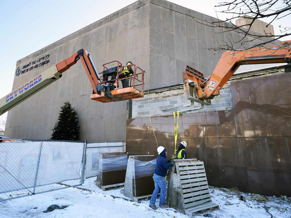 Workers begin demolition on  Wednesday at the Tree of Life building in Pittsburgh as part of the effort to reimagine the building to honor the 11 people who were killed there in 2018.