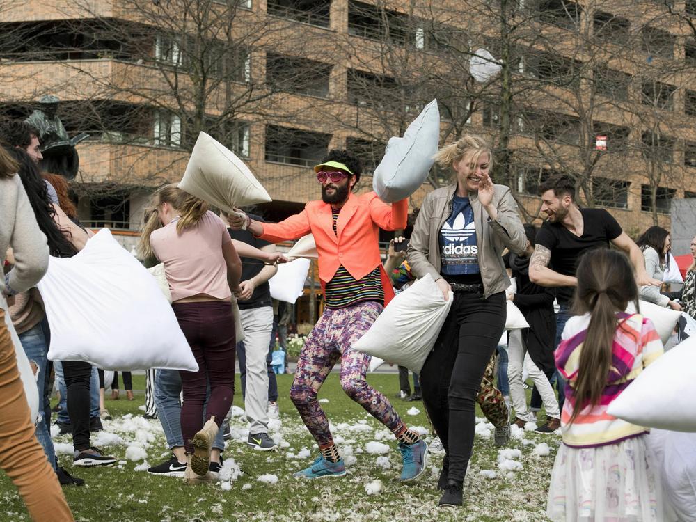 People take part in the annual International Pillow Fight Day in Rotterdam, Netherlands, in 2018.