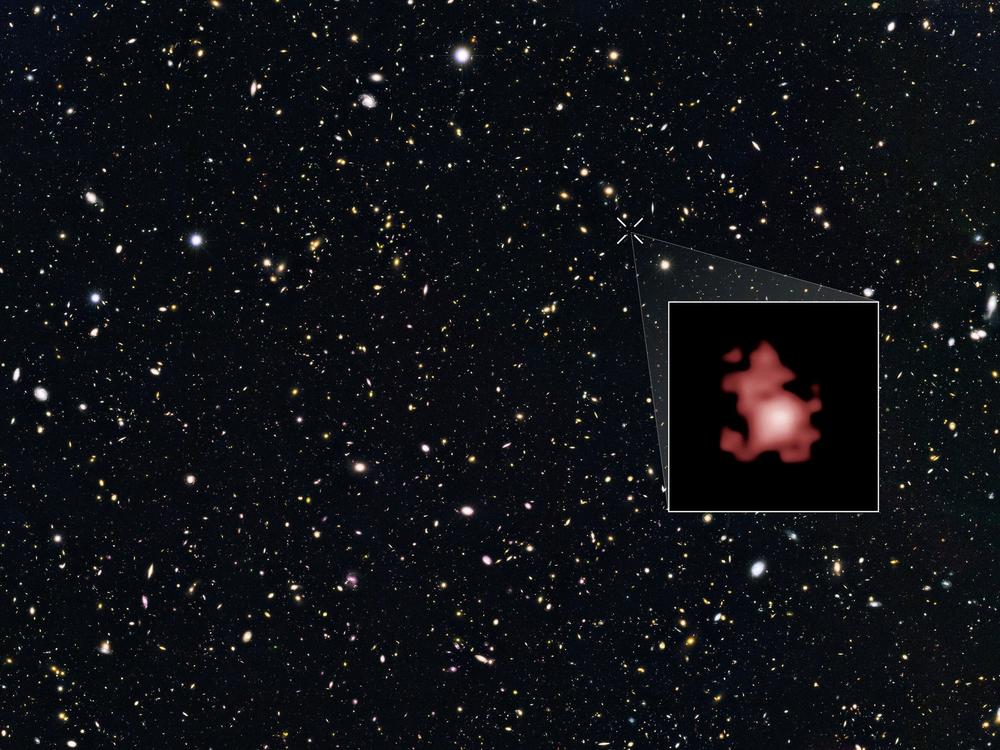 This image shows a 'close-up' of the galaxy GN-z11 as imaged by the Hubble Space Telescope, superimposed on top of another image marking the galaxy's location in the sky.