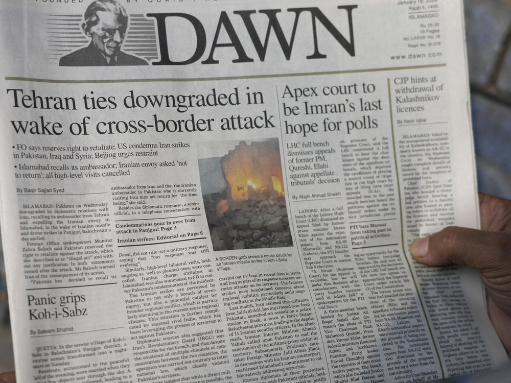 A Pakistani reads the front page of a morning newspaper covering Iran's strike, at a stall in Islamabad, Pakistan, Thursday, Jan. 18, 2024.