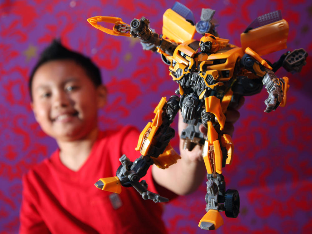 A boy holds a Transformers robot figure in 2011. The toys that became a global sensation started out as transforming robot toys in Japan in the early 1980s.
