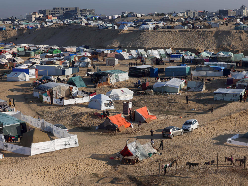 Displaced Palestinians take shelter in a makeshift tent camp by the beach in Rafah near the border with Egypt in the southern Gaza Strip on Tuesday, amid the ongoing conflict between Israel and the Palestinian militant group Hamas.