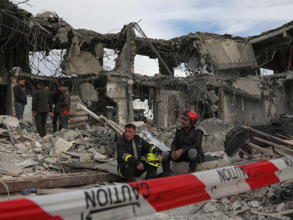 A civil defense team carries out search-and-rescue operations in a damaged building following a missile strike launched by Iran on Irbil, the capital of northern Iraq's Kurdish region, on Tuesday.