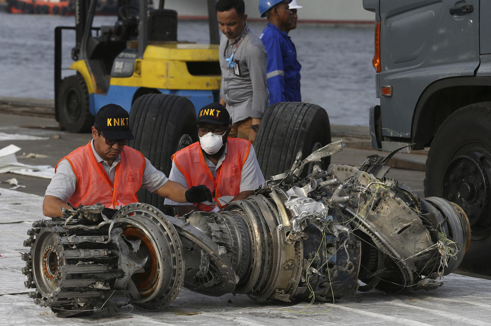 Officials in Jakarta, Indonesia, inspect an engine recovered in November 2018 from a Boeing 737 Max 8 flown by Indonesia's Lion Air that crashed.