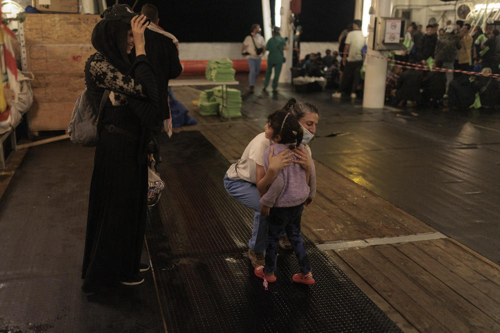Members of the Doctors Without Border rescue crew welcome Aya and Reem al-Sakr and the children onboard the ship.