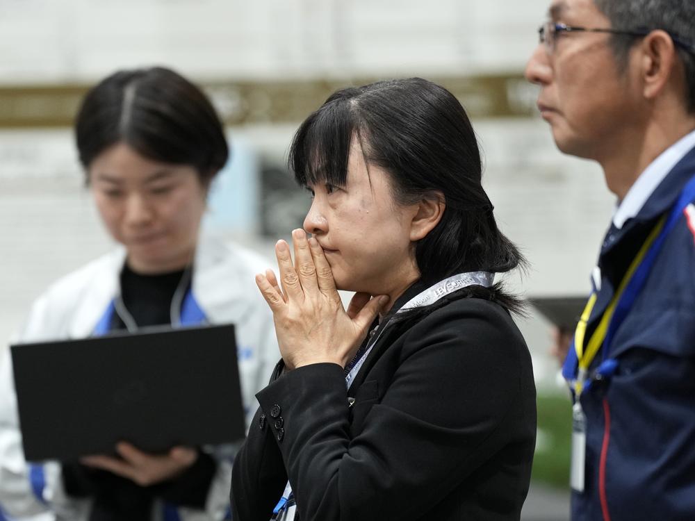 Staff of the Japan Aerospace Exploration Agency (JAXA) watch a live stream of the moon landing by the Smart Lander for Investigating Moon (SLIM) spacecraft at JAXA's Sagamihara Campus near Tokyo.