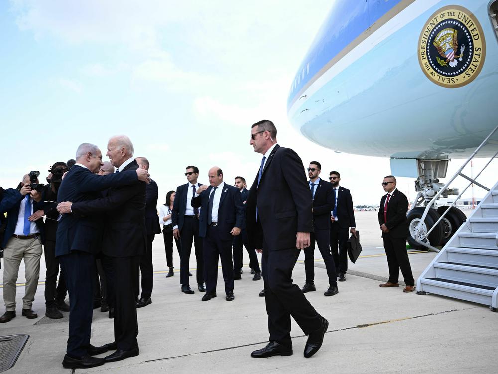 Israeli Prime Minister Benjamin Netanyahu hugs President Biden as he arrives in Tel Aviv on Oct. 18, 2023.